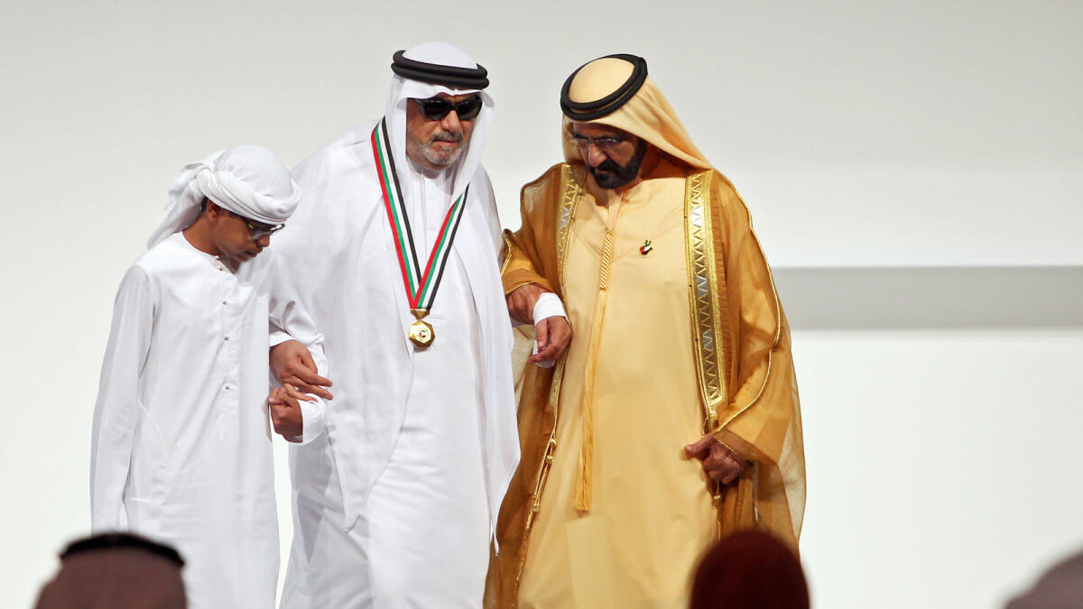 Shaikh Mohammed honouring Ahmed Mukhtar Ahmed Ali, the first blind teacher, at the UAE Pioneers Award Ceremony.