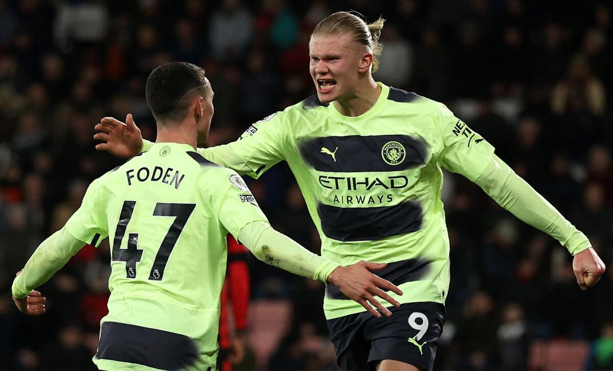 Manchester City's Erling Haaland (right) celebrates with Phil Foden on Saturday. — AFP
