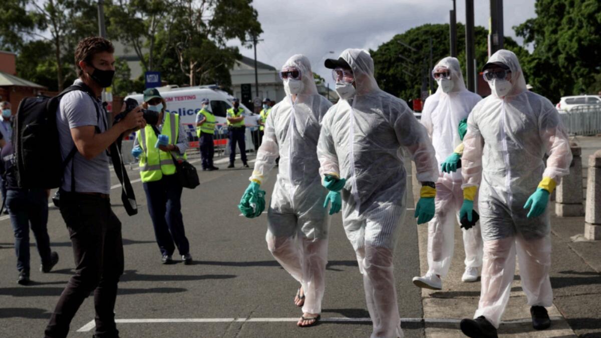 Cricket fans wearing PPEs arrive at the Sydney Cricket Ground for India-Australia test match.  — Reuters