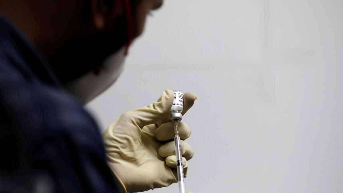 A medic fills a syringe with COVAXIN, an Indian government-backed experimental COVID-19 vaccine at the Gujarat Medical Education and Research Society in Ahmedabad, India, November 26, 2020.