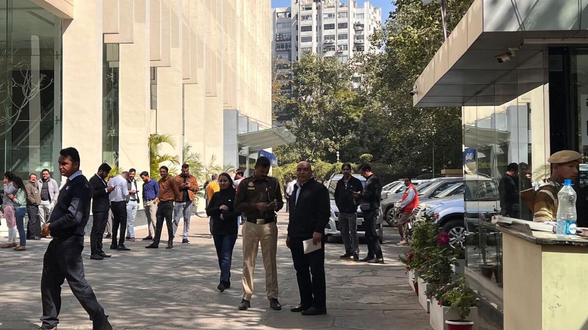 A police officer stands at the entrance of the office building where tax authorities raided BBC’s office in New Delhi. — AFP