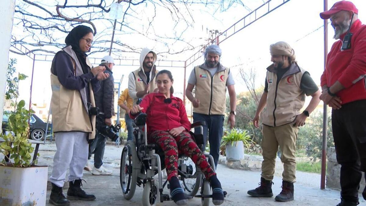 ERC team with a beneficiary who received electric wheelchair in Syria. — Wam