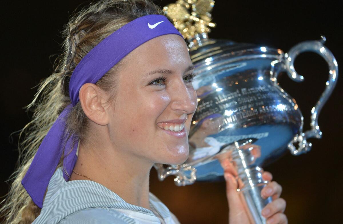 Victoria Azarenka poses with the trophy after her victory over China's Li Na in the women's singles final at the 2013 Australian Open in Melbourne. — AFP file