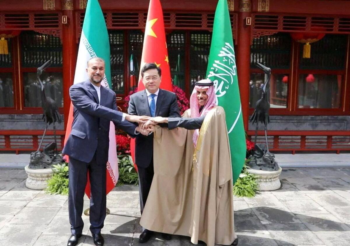 Iranian Foreign Minister Hossein Amir-Abdollahian and Saudi Arabia's Foreign Minister Prince Faisal bin Farhan Al Saud and Chinese Foreign Minister Qin Gang shake hands during a meeting in Beijing on Thursday. — Reuters