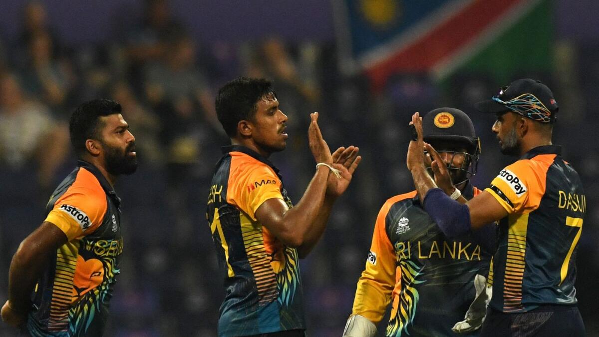 Sri Lanka's Maheesh Theekshana (second from left) celebrates with teammates after taking the wicket of Namibia's Jan Frylinck in Abu Dhabi on Monday. — AFP