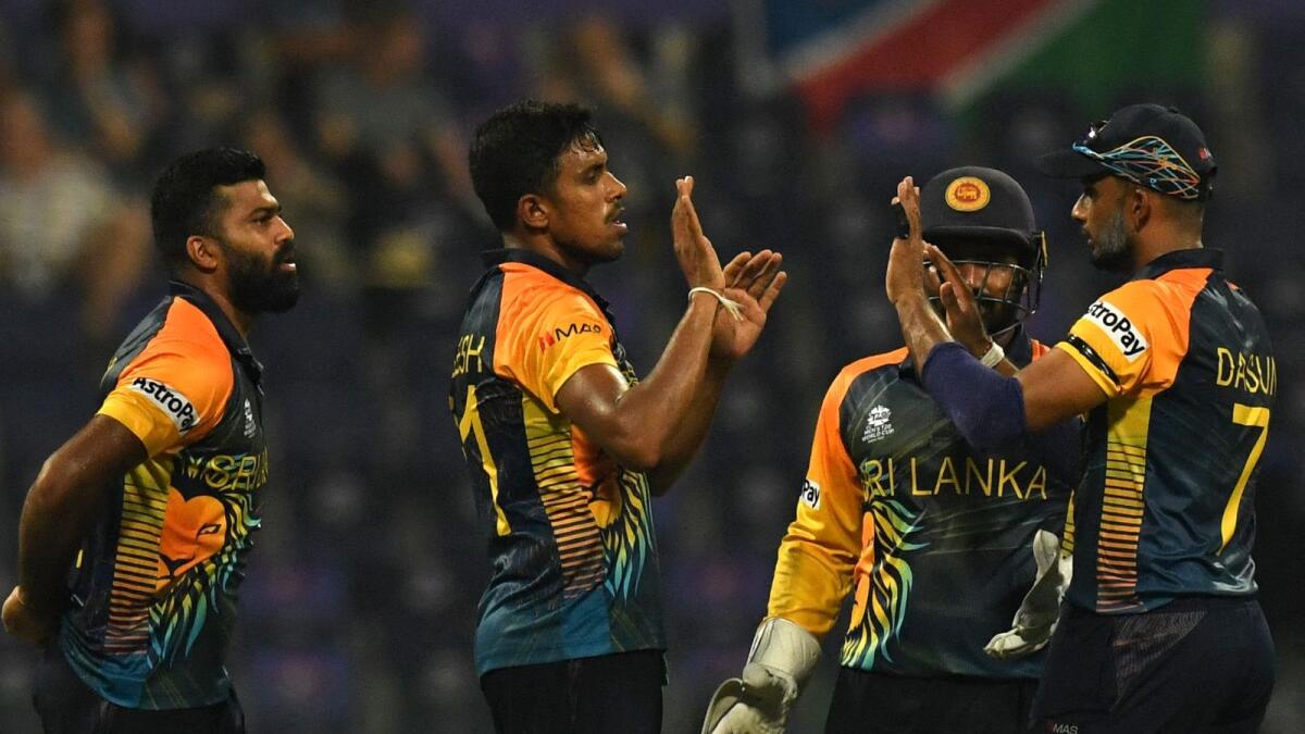 Sri Lanka's Maheesh Theekshana (second from left) celebrates with teammates after taking the wicket of Namibia's Jan Frylinck in Abu Dhabi on Monday. — AFP