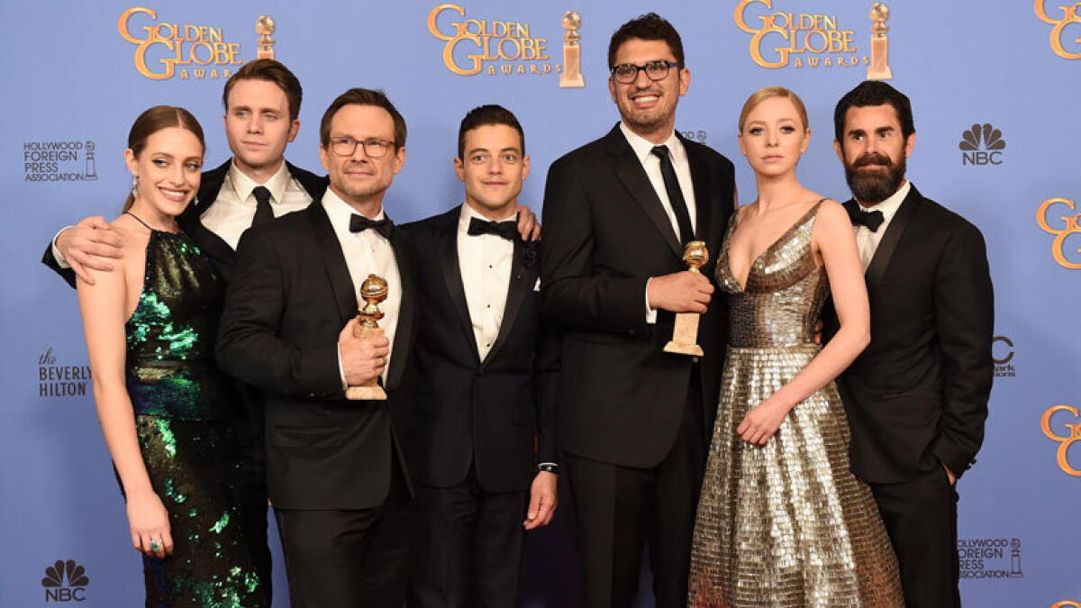 Carly Chaikin, Martin Wallstrom, Christian Slater, and Rami Malek, writer/producer Sam Esmail, actress Portia Doubleday, and producer Chad Hamilton, winners of Best Series - Drama for “Mr. Robot”. Photo: AFP