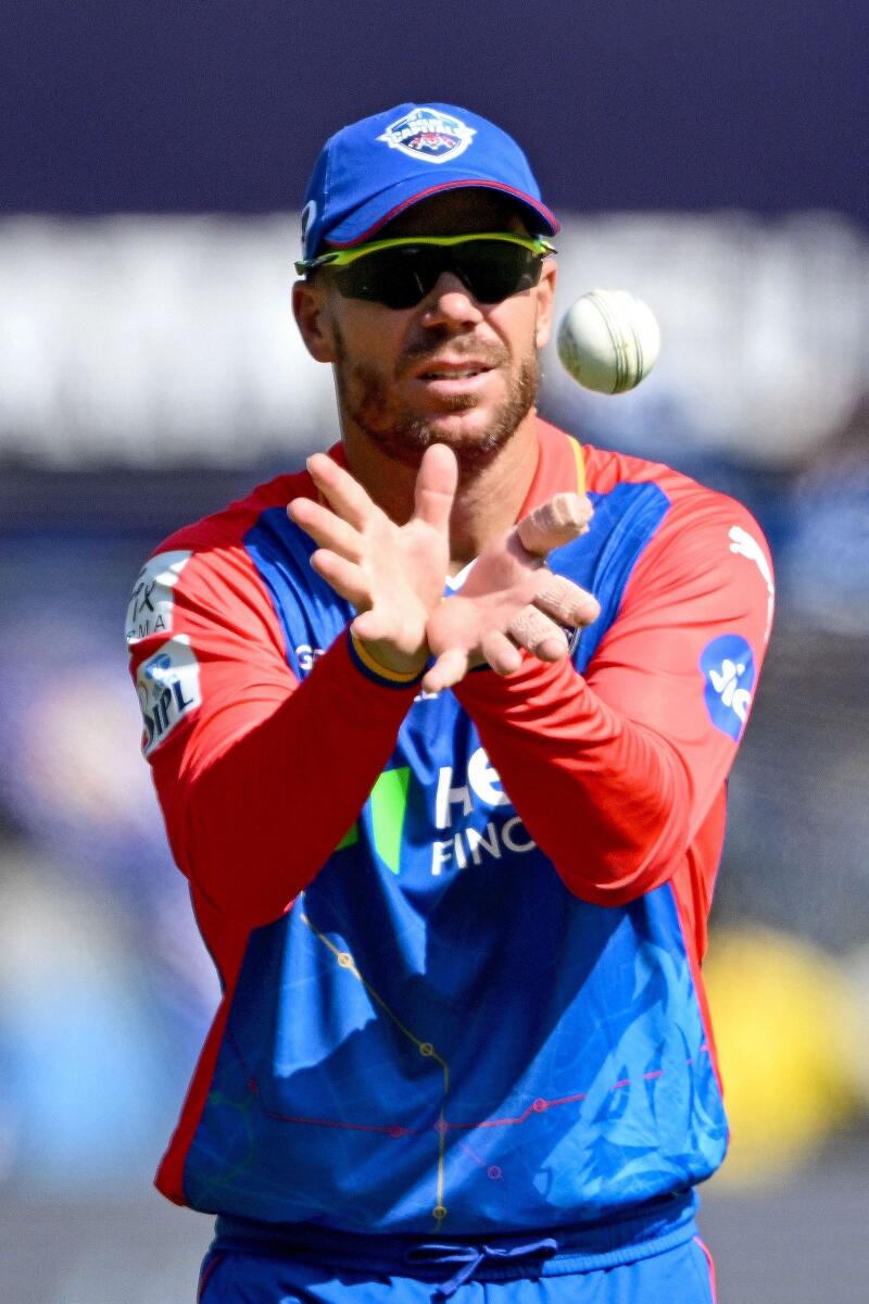 Delhi Capitals' David Warner catches the ball during the IPL match against Mumbai Indians. — AFP