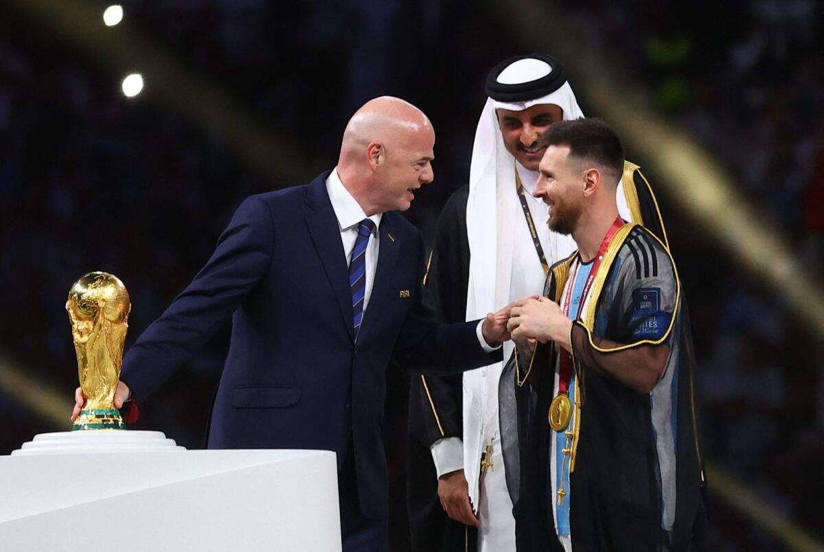 Argentina's Lionel Messi with FIFA president Gianni Infantino and the Emir of Qatar Sheikh Tamim bin Hamad Al Thani