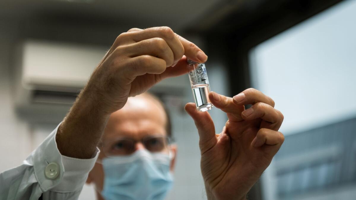A laboratory assistant holds a tube with Russia's 'Sputnik-V' vaccine against the coronavirus disease (COVID-19) at the National Institute of Pharmacy and Nutrition in Budapest, Hungary, November 19, 2020.