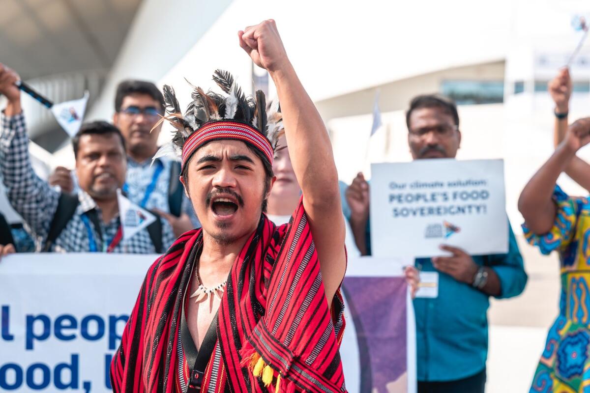 Nedlloyd Yang-Ed Tuguinay shouts slogans at a protest along with rural people who have united for food, land and climate justice at COP28 in Dubai. Photo: Neeraj Murali