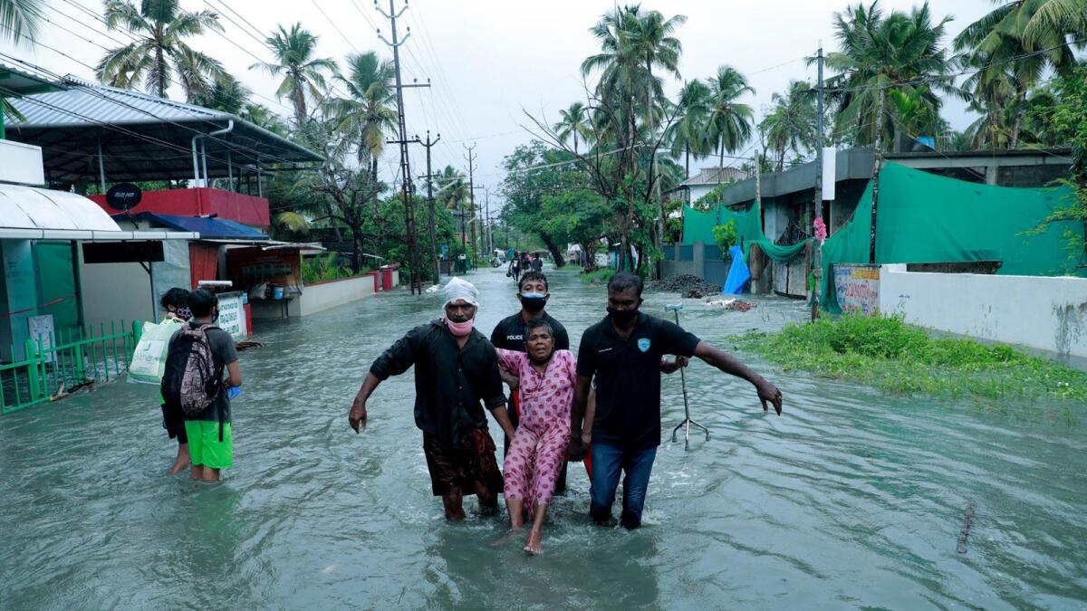 Rescue personnel evacuate residents through a flooded street in Kochi, Kerala following heavy rains brought by cyclone 'Tauktae'. Photo: AFP