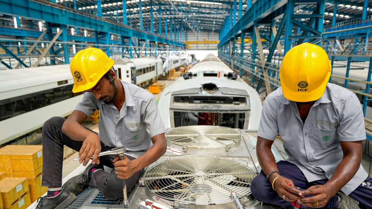 Workers at a railway coach manufacturing facility in Chennai. — PTI
