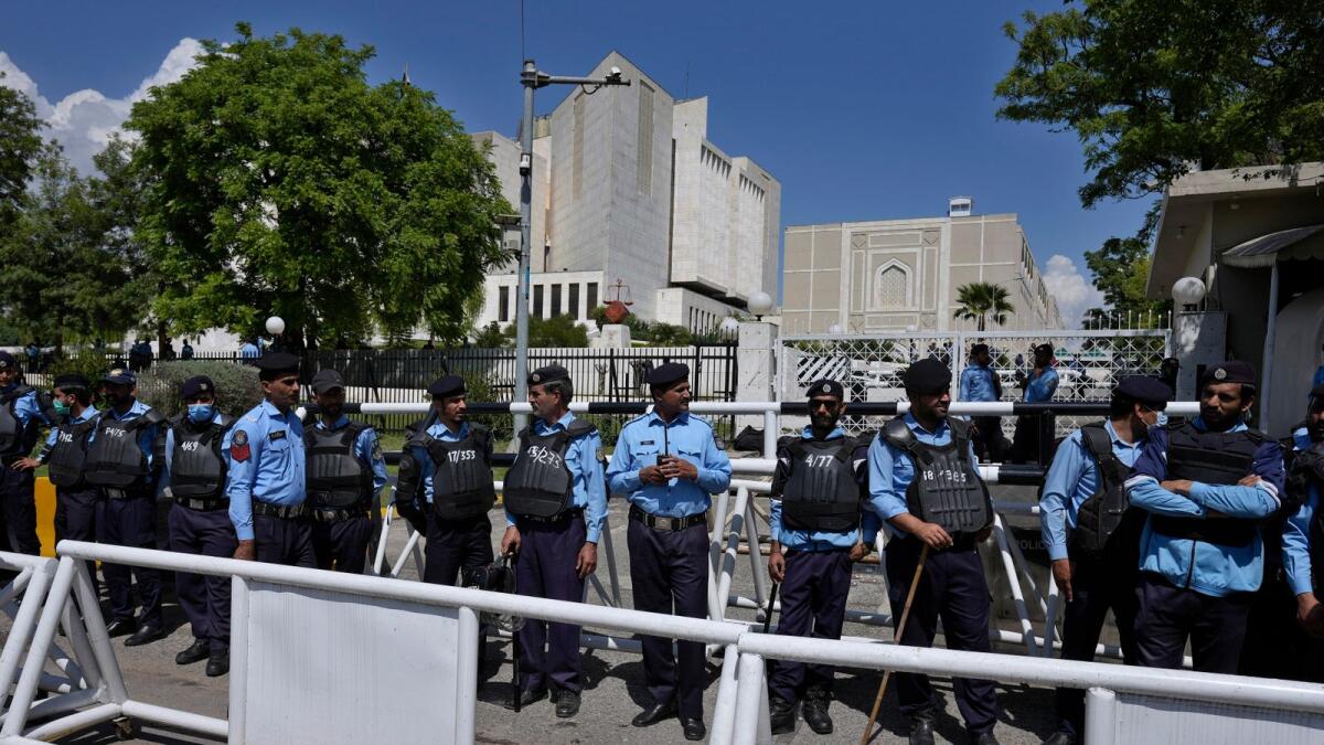 Police officers stand guard outside the Supreme Court in Islamabad. — AP file
