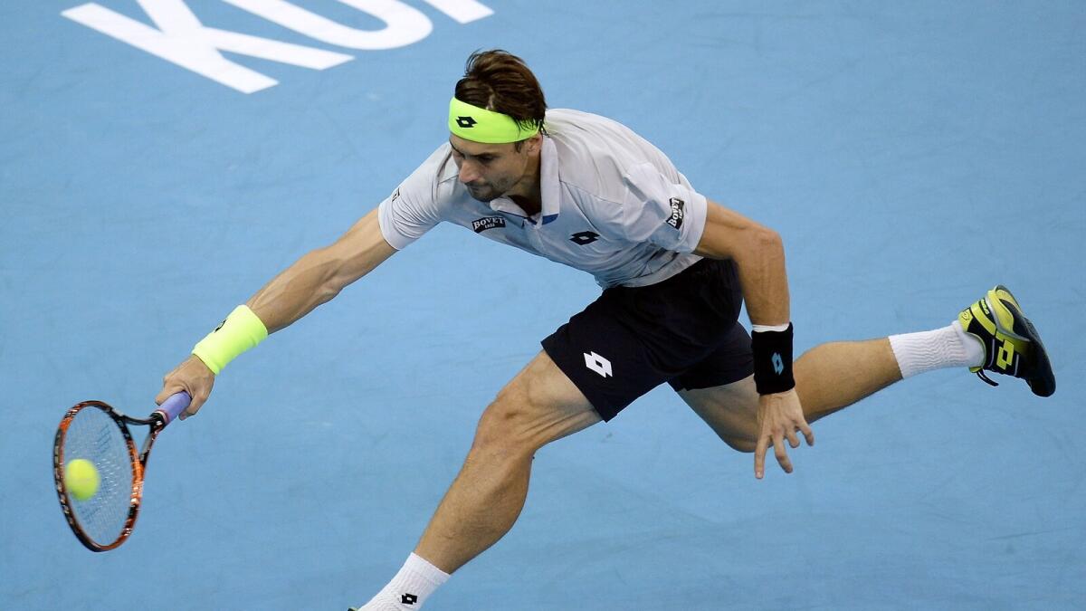 Spain’s David Ferrer hits a return against compatriot Feliciano Lopez during the men’s singles final at the 2015 Malaysian Open. 