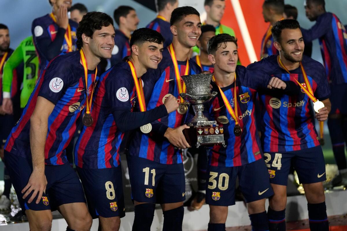 Barcelona players celebrate with the trophy after they beat Real Madrid in Riyadh. -- AP