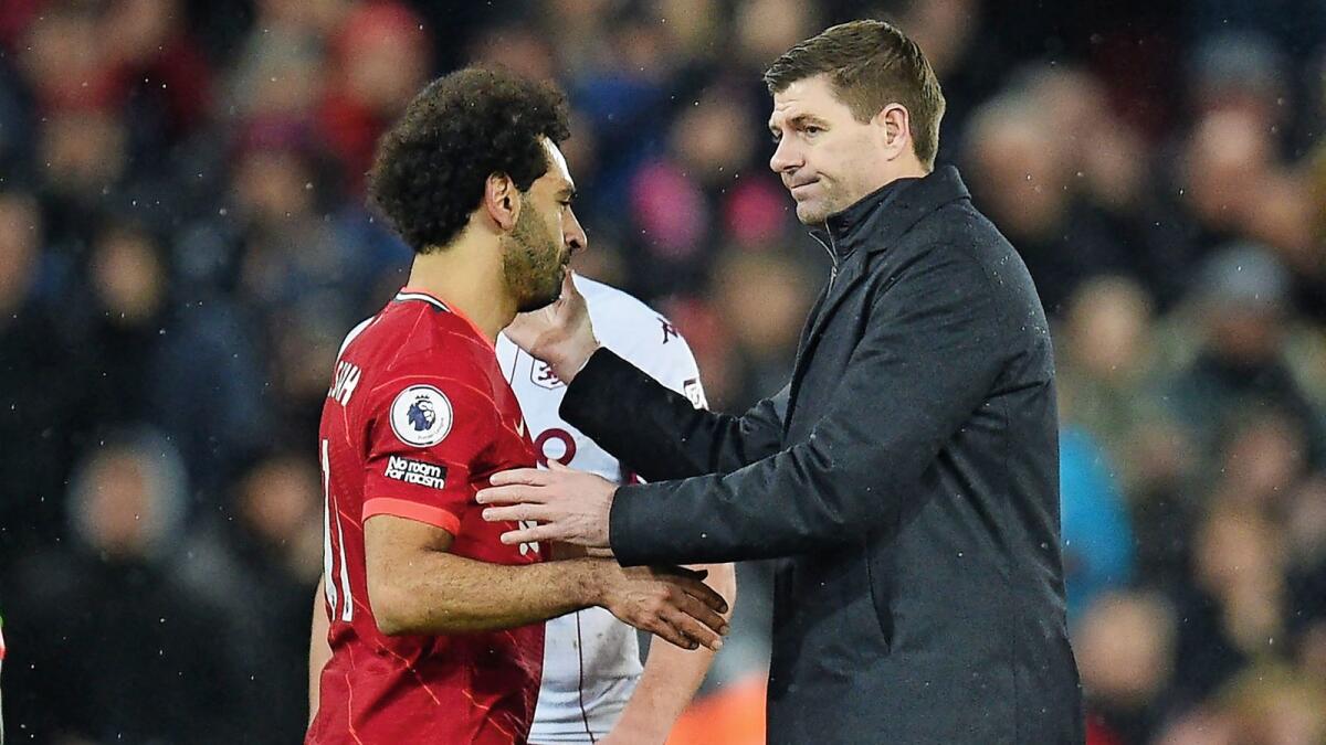Aston Villa manager Steven Gerrard (right) and Liverpool's Mohamed Salah greet each other after the game at Anfield on Saturday. — AFP