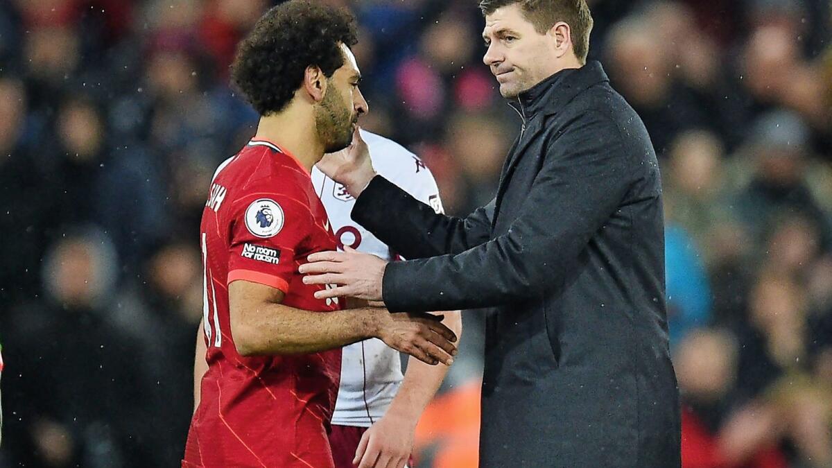 Aston Villa manager Steven Gerrard (right) and Liverpool's Mohamed Salah greet each other after the game at Anfield on Saturday. — AFP