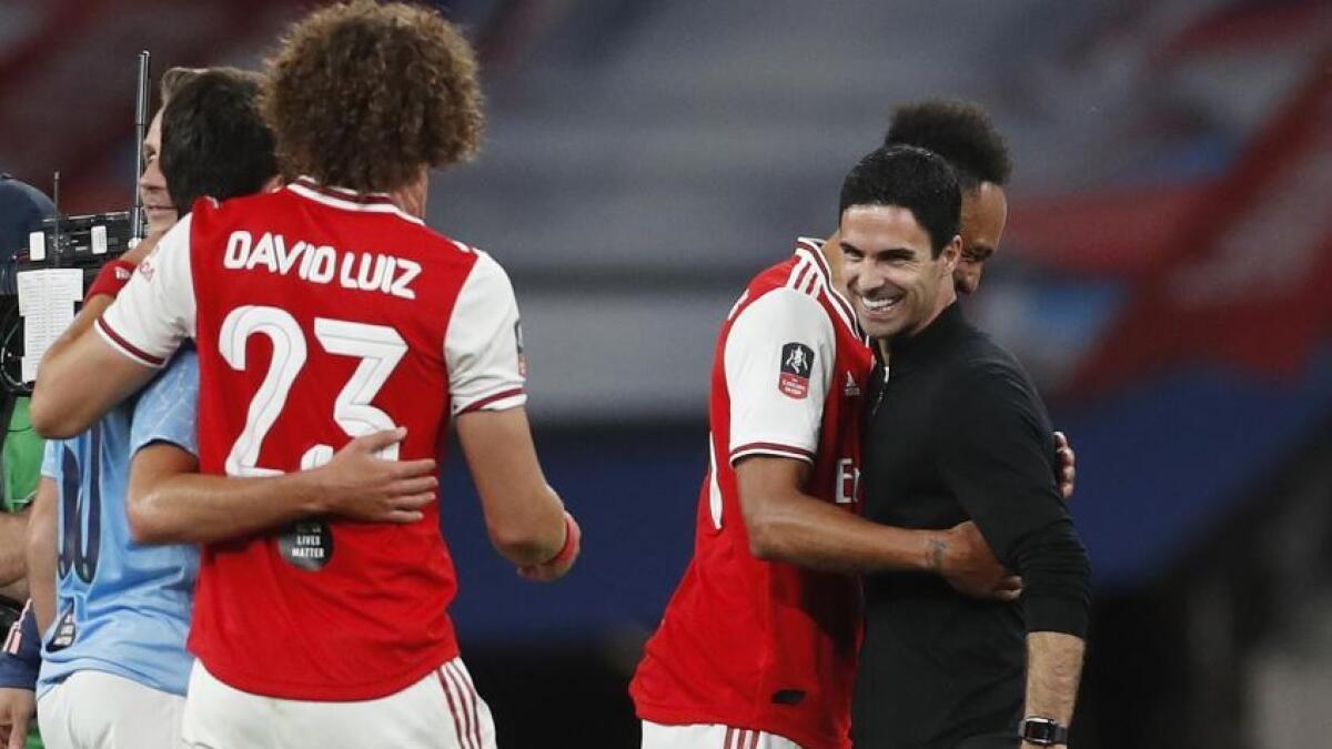Arsenal's Pierre-Emerick Aubameyang, David Luiz and manager Mikel Arteta celebrate after the match. (Reuters)