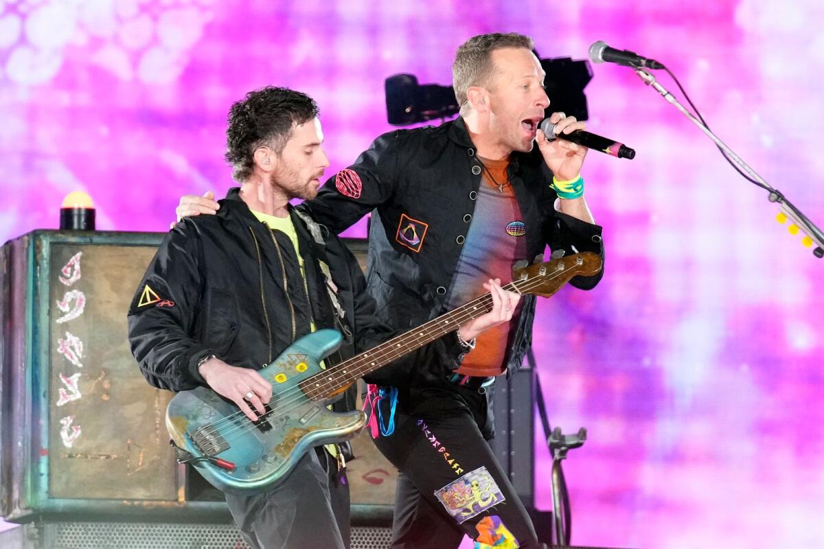 Guy Berryman, left, and Chris Martin of Coldplay performs during the band's Music of the Spheres world tour.