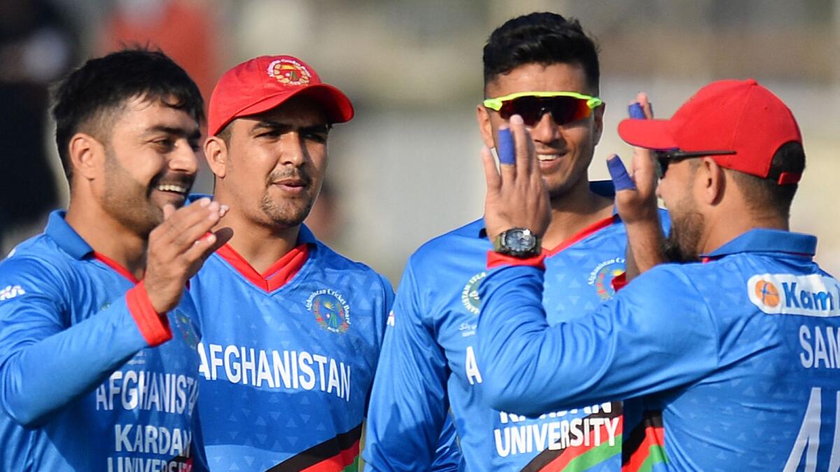 Afghanistan's Rashid Khan (left) celebrates a wicket with teammates. (AFP file)