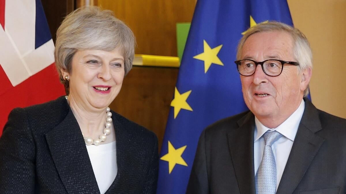 European Commission President Jean-Claude Juncker (R) welcomes British Prime Minister Theresa May (L) prior to their meeting in Strasbourg.-AFP 