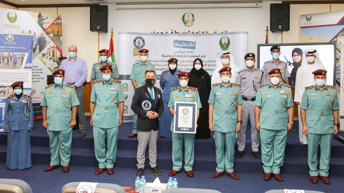 Ajman Police officials receive Guinness World Record certificate. — Supplied photo
