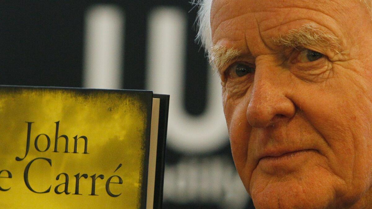 John le Carre holds a copy of his new book entitled 'Our Kind of Traitor' at a central London bookstore during a book signing event to mark the launch of the novel in London. Photo: AP file