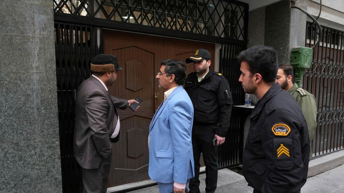 Police and judiciary officials in front of the door of the building of the Azerbaijan Embassy in Tehran, Iran. – AP
