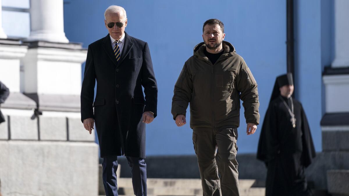 Joe Biden walks with Volodymyr Zelensky at St. Michael's Golden-Domed Cathedral in Kyiv. — AP