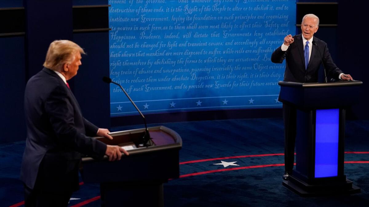 Joe Biden (R) points toward Donald Trump during the final presidential debate at Belmont University in Nashville, Tennessee, on October 22, 2020.  AFP