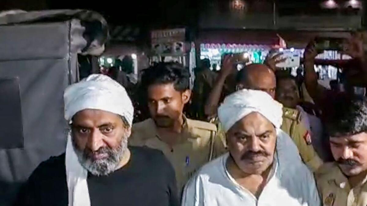Gangster-turned-politician Atiq Ahmed and his brother Ashraf Ahmed being escorted to a hospital by police for a medical checkup in Prayagraj on April 15, 2023. Atiq and Ashraf were shot dead by unidentified assailants while being taken for the medical. — PTI