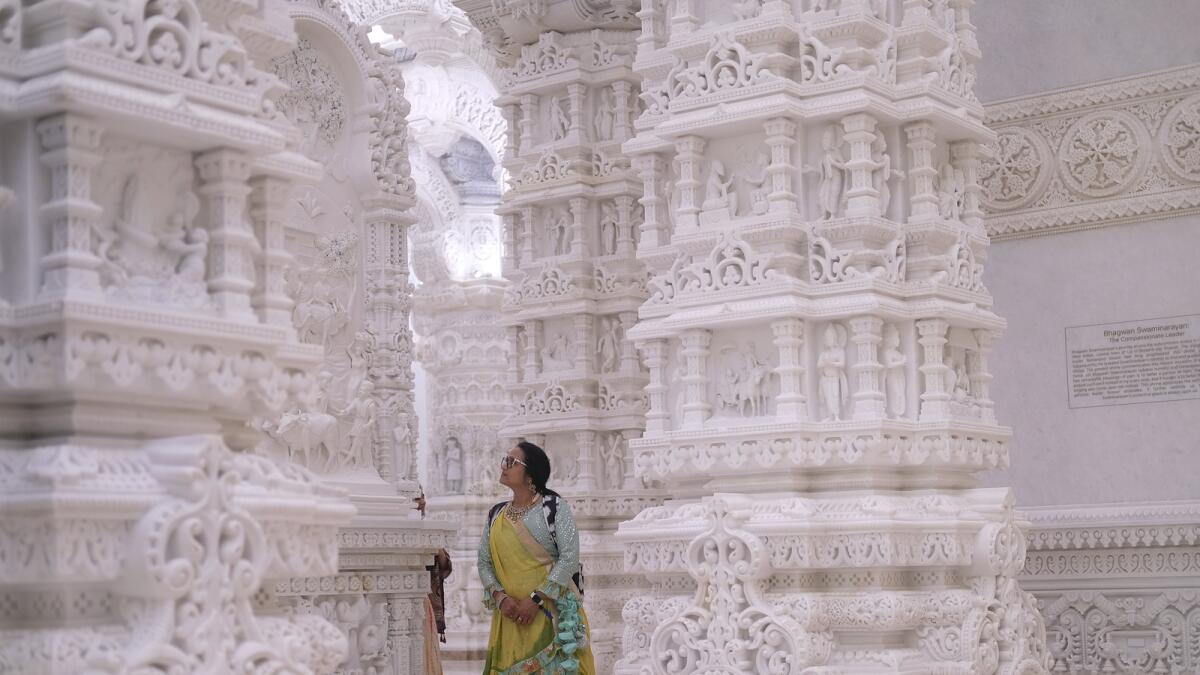 A woman admires the intricate architecture of the BAPS Swaminarayan Akshardham. — AP