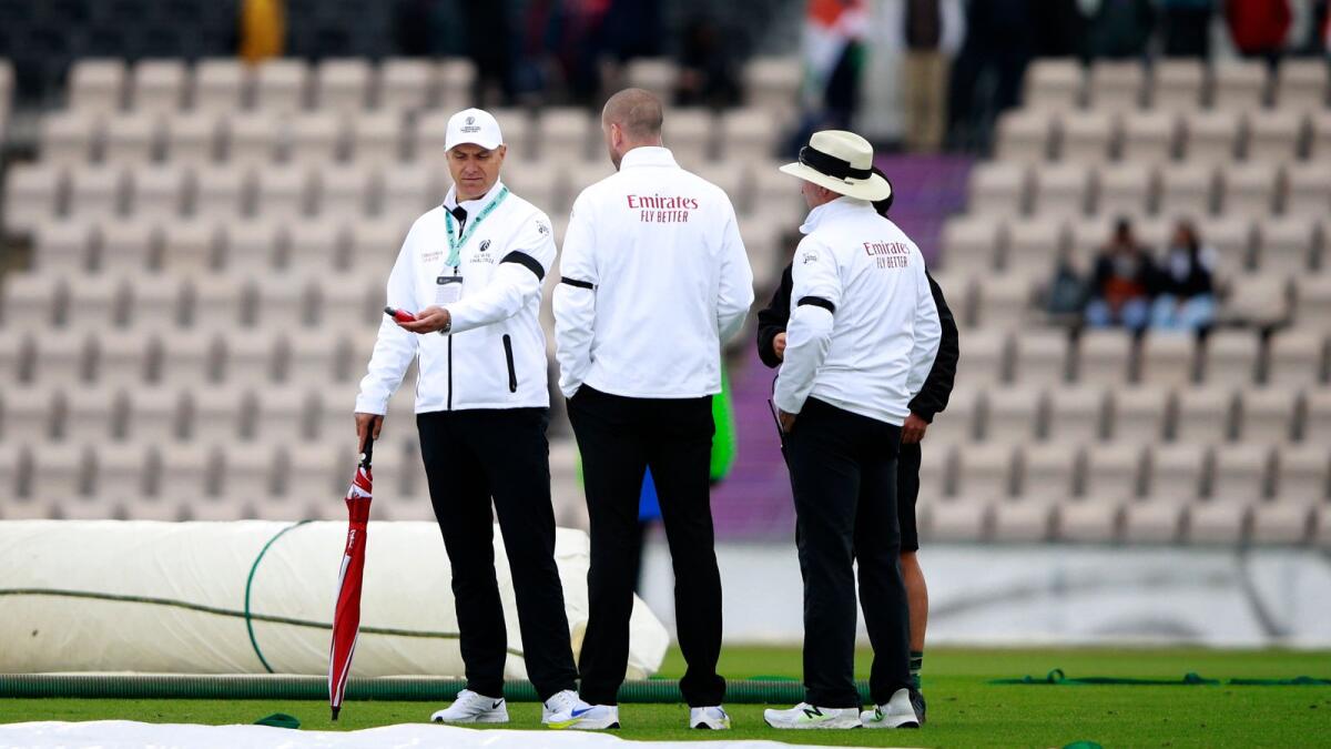 Umpires use a light meter after bad light stopped play during the second day of the World Test Championship final between New Zealand and India.— AP