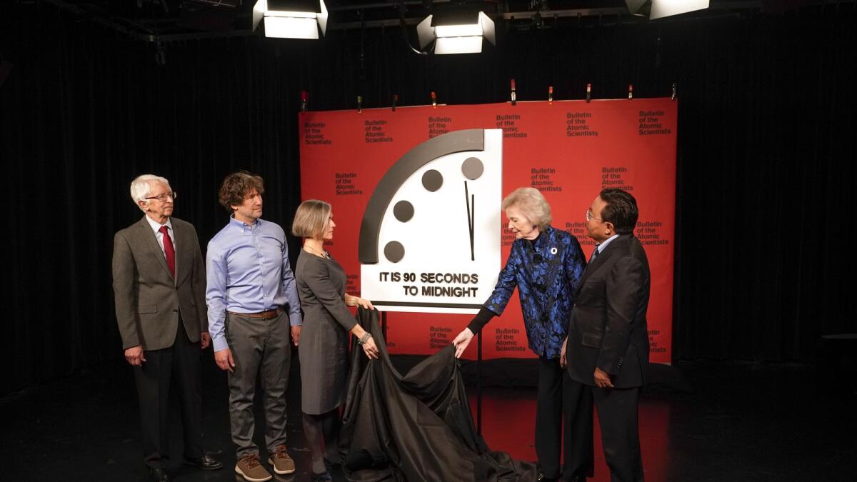 Siegfried Hecker, from left, Daniel Holz, Sharon Squassoni, Mary Robinson and Elbegdorj Tsakhia with the Bulletin of the Atomic Scientists, remove a cloth covering the Doomsday Clock before a virtual news conference at the National Press Club in Washington, on Tuesday.— AP