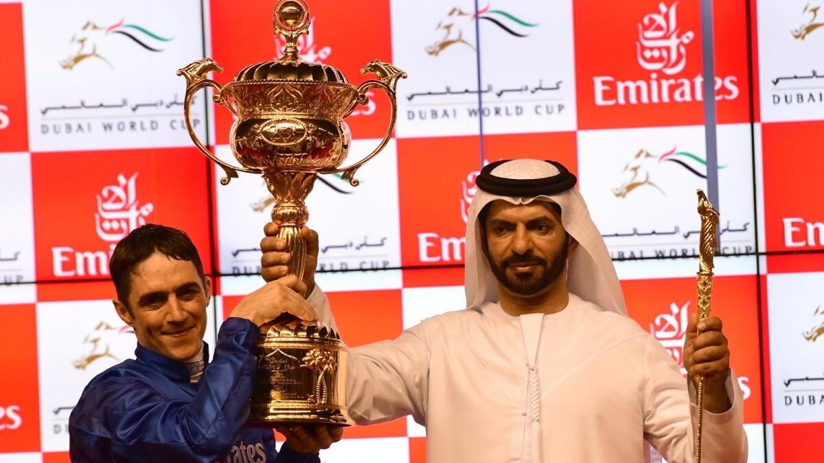 Saeed bin Suroor (right) and jockey Christophe Soumillon hold the trophies after Thunder Snow won the Group 1 Dubai World Cup in 2018. — AP file