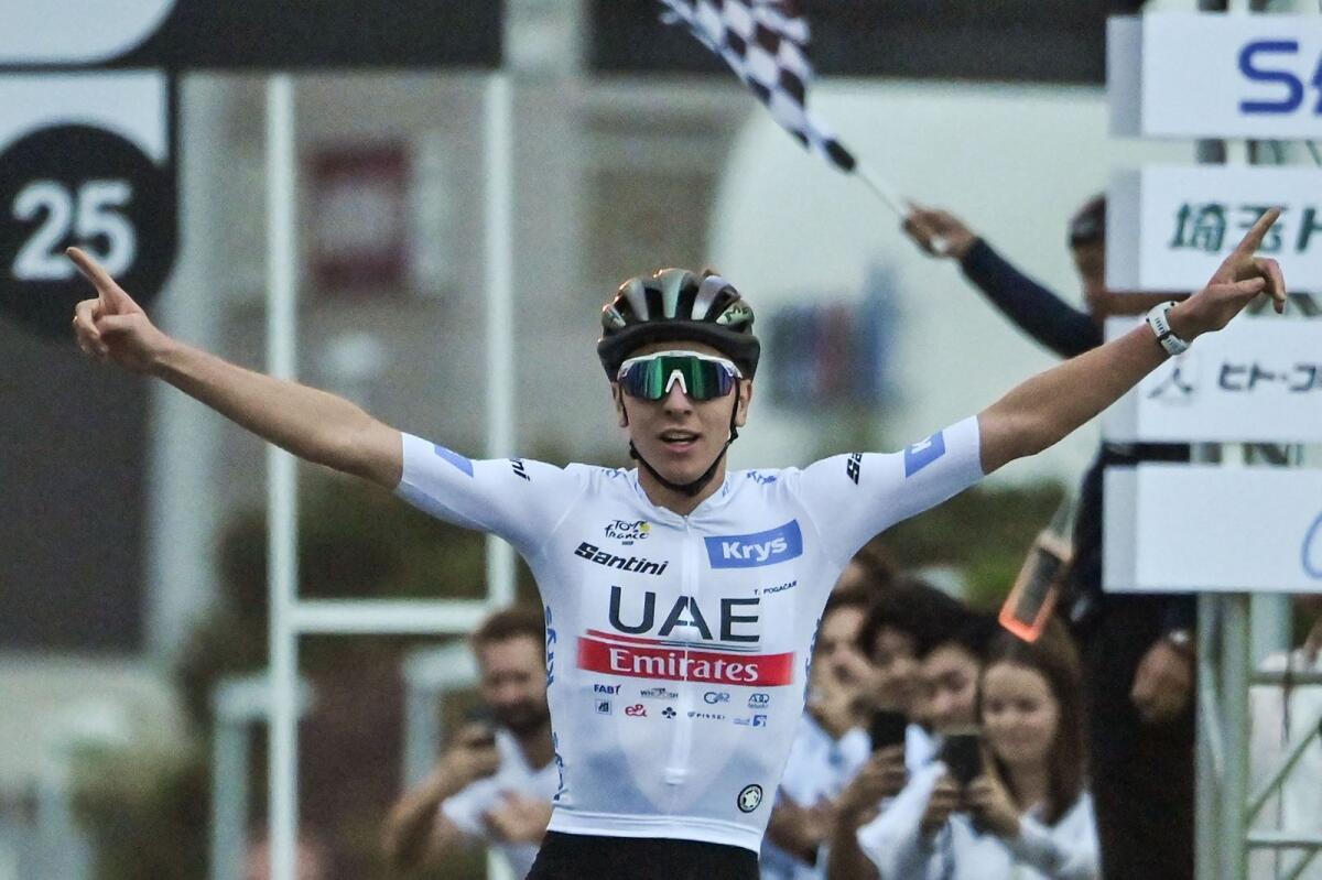 UAE Team Emirates' Tadej Pogacar of Slovenia celebrates as he crosses the finish line to win the Saitama Criterium in Saitama on Sunday. — AFP