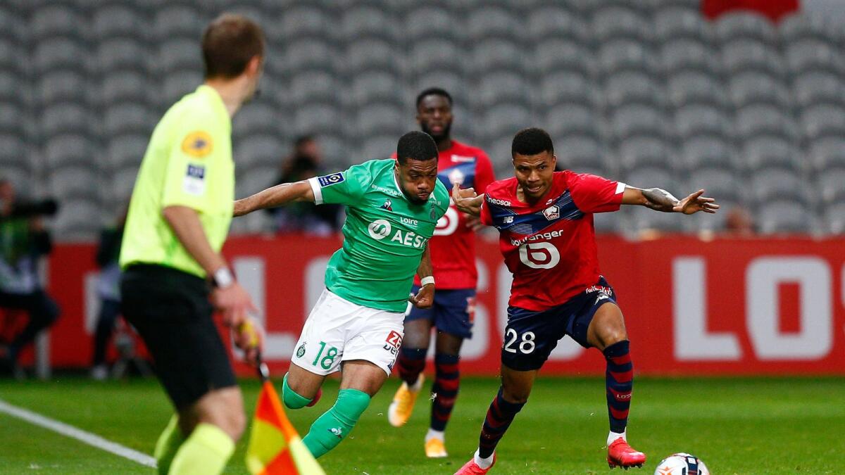 Saint-Etienne's Arnaud Nordin (left) vies for the ball with Lille's Xeka during the French League One match. — AP