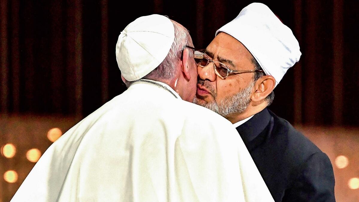 Pope Francis and Al Azhar Grand Imam Dr Ahmed El Tayeb greeting each other as they exchange the Abu Dhabi Document during the Human Fraternity Meeting at the Founder’s Memorial. — AFP