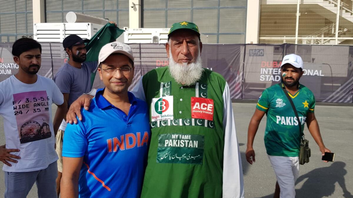 'Chacha' Abdul Jalil (right) with Indian fan Kapil Dev at the Dubai International Cricket Stadium on Sunday. — Rituraj Borkakoty