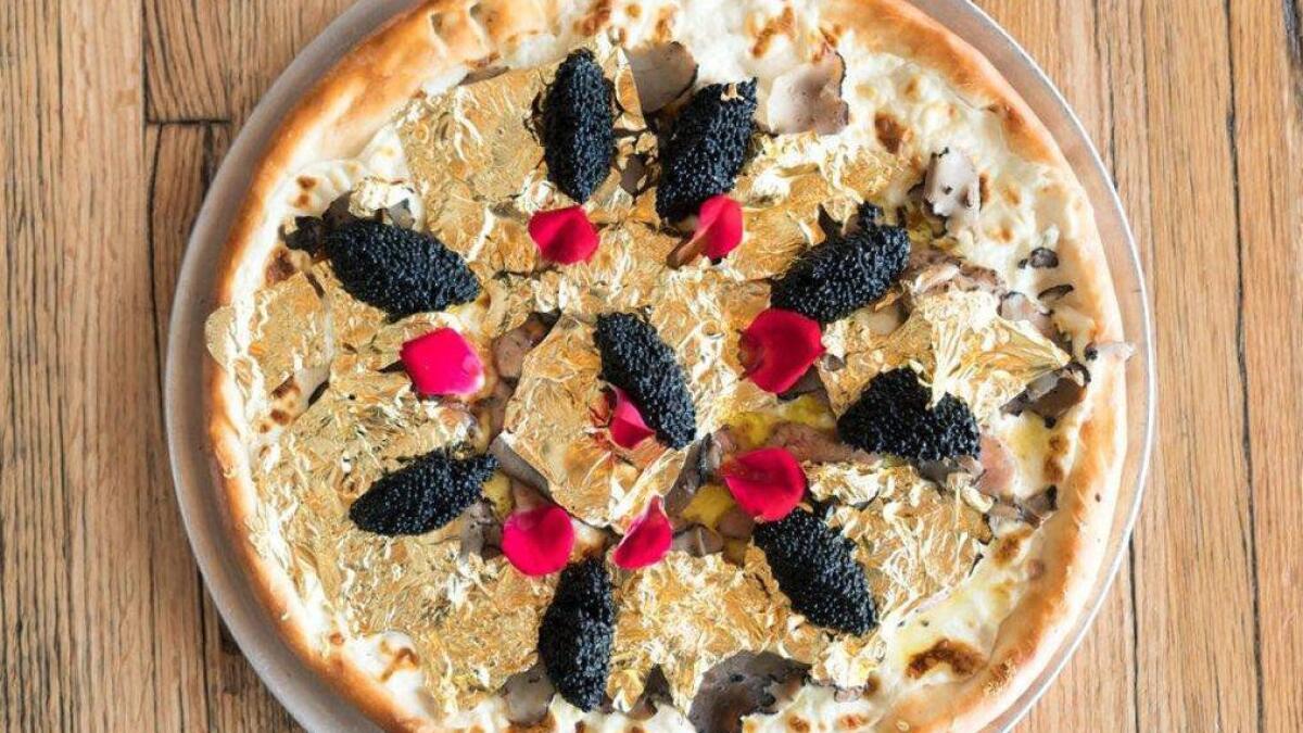 This restaurant serves Dh7,300 pizza thats plated with 24K gold