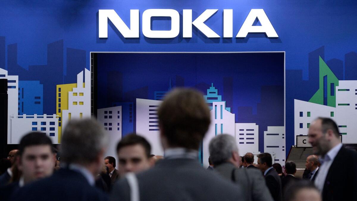 People visiting the Nokia stand at the Mobile World Congress in Barcelona. Finnish telecoms equipment maker Nokia said on March 16, 2021 it would slash up to 10,000 jobs over the next two years as part of a 600-million-euro ($715-million) cost-cutting programme. — AFP file