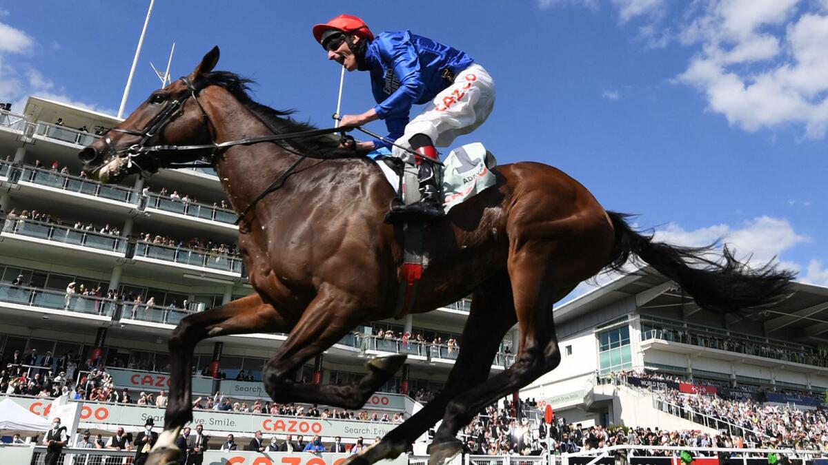 Adam Kirby rides Adayar to victory during the English Derby. — AFP