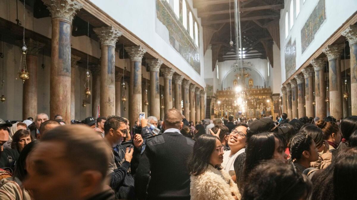 People visits the Church of the Nativity in the West Bank town of Bethlehem on Saturday. — AP