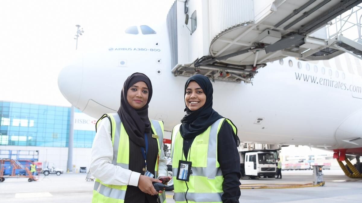 Ground Dispatcher Muna Al Balooshi and Cargo Operations Controller Aisha Alyafaei preparing flight EK 225 for departure.