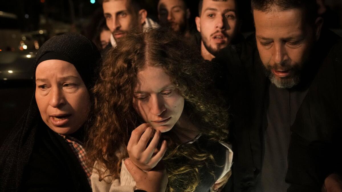 Palestinian activist Ahed Tamimi (centre) is supported by her mother after she was released from prison by Israel in the West Bank town of Ramallah, early on Thursday, November 30. — AP