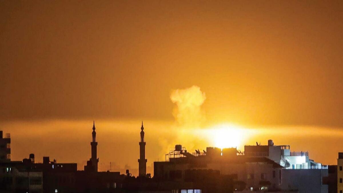 An explosion is seen in Gaza City after an air strike by Israel. — AFP