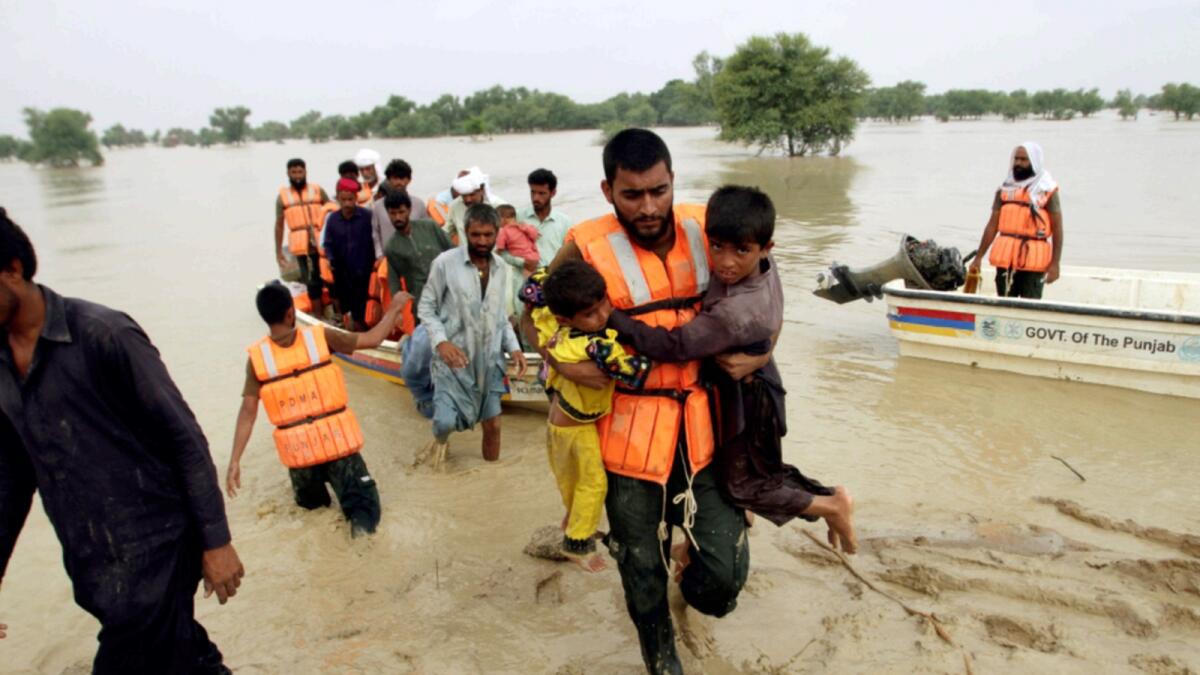 Army troops evacuate people from a flood-hit area in Rajanpur in Pakistan. — AP file