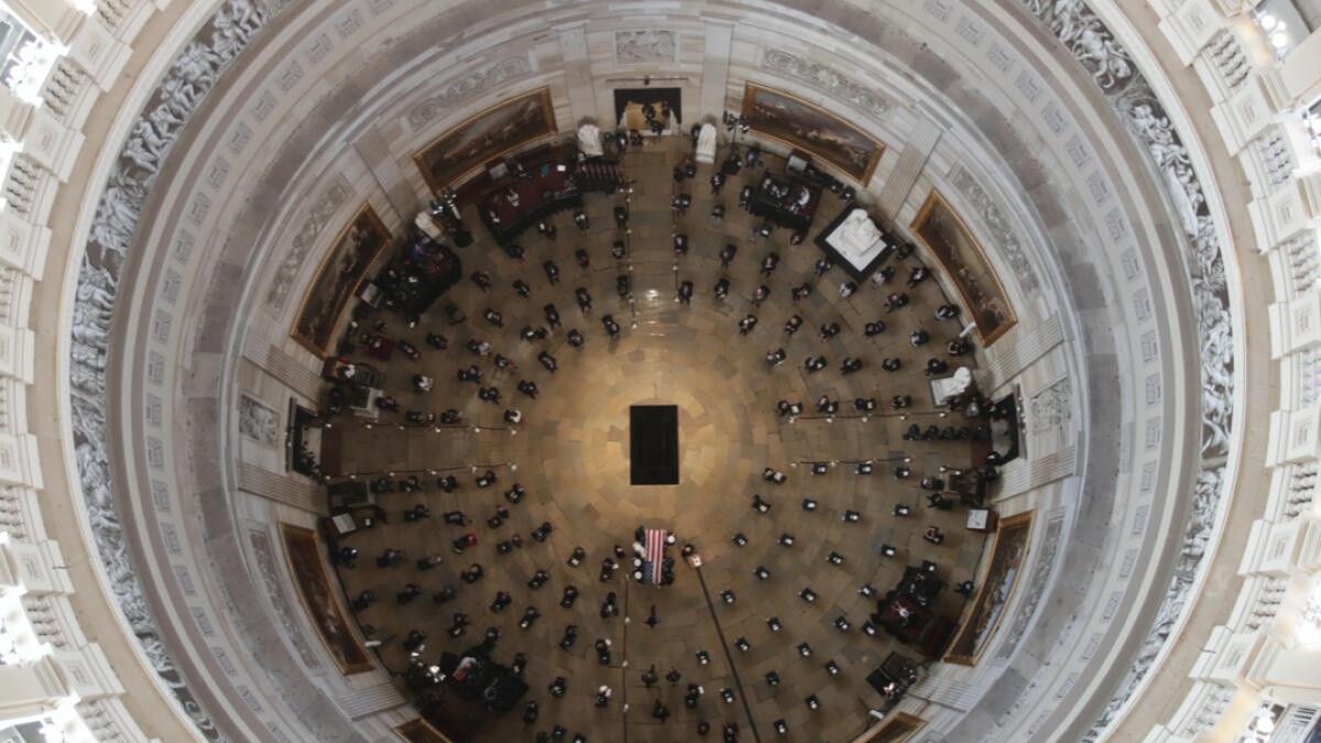 The flag-draped casket of civil rights pioneer Rep. John Lewis, D-Ga., who died July 17, is carried by a US military honor guard to the center of the US Capitol Rotunda to lie in state in Washington, Monday. Photo: AP