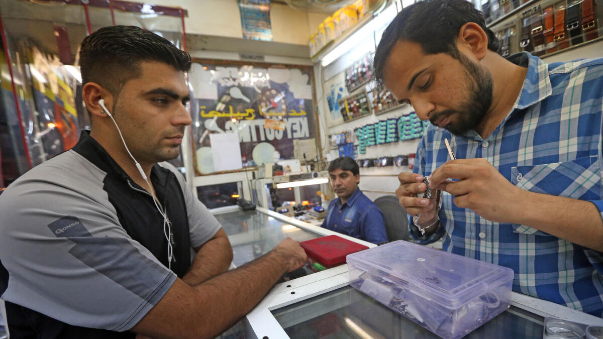 WATCH-FUL EYES... A customer giving specific instructions to Irfan Shahid how he wants his watch repaired.